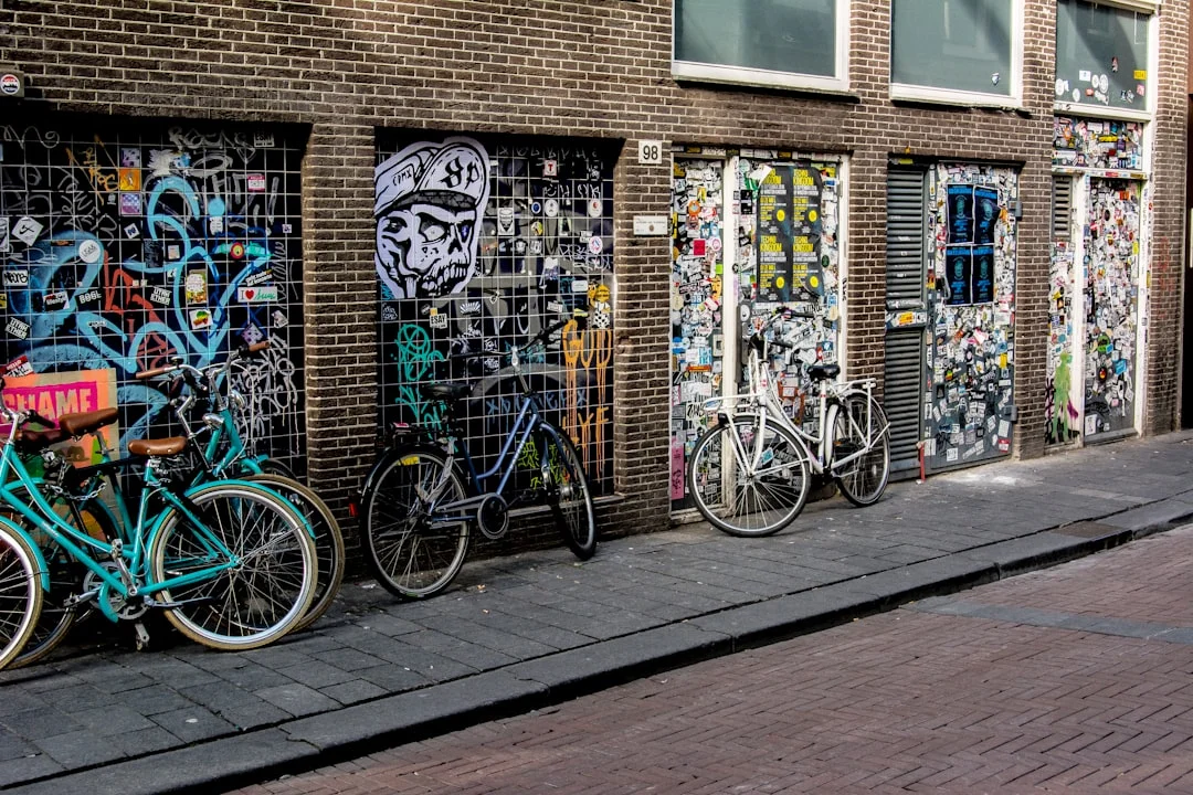 bicycle parked beside brown brick wall